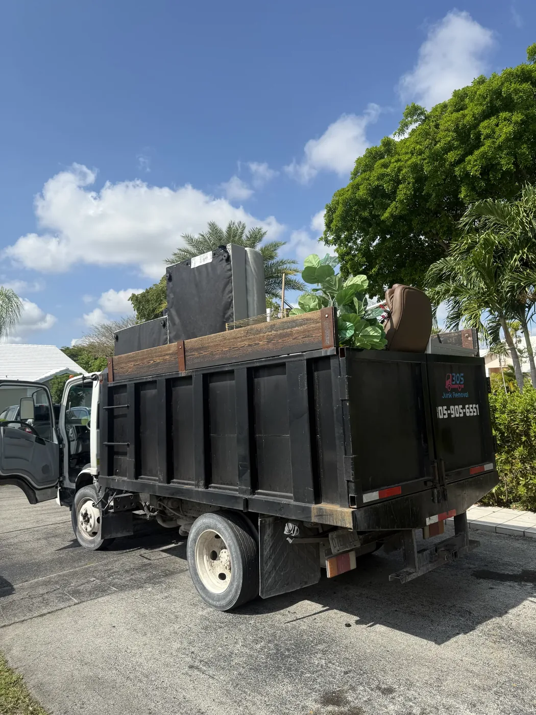 Loaded junk removal truck at a residential pickup